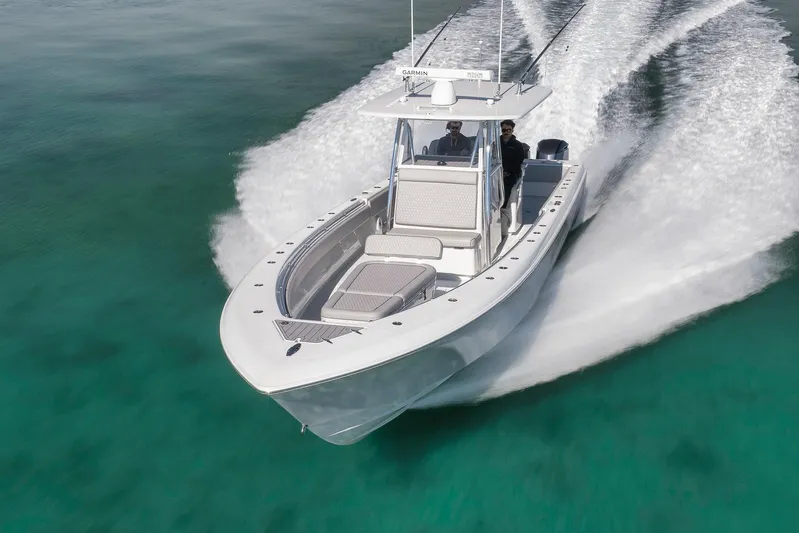  Yacht Photos Pics 2021 Contender 39 ST boat cruising on clear turquoise water.