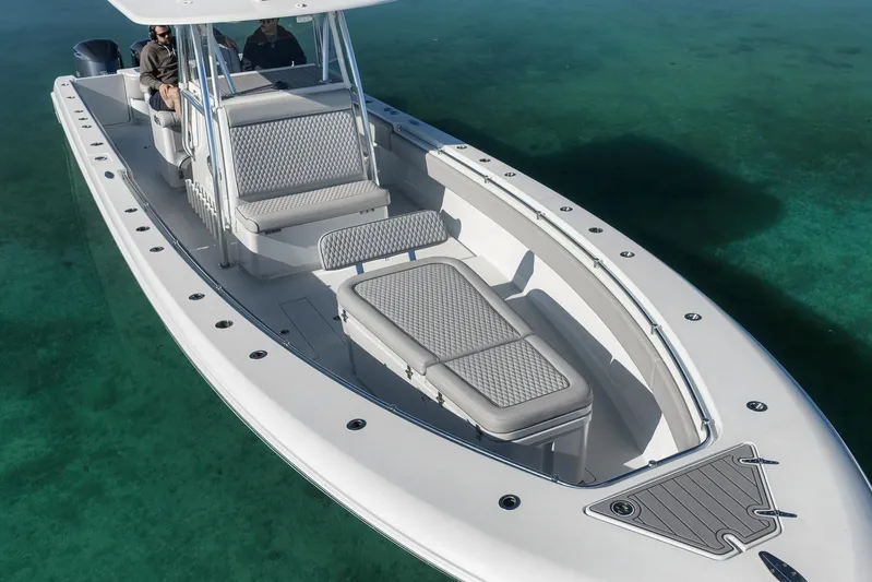  Yacht Photos Pics 2021 Contender 39 ST boat on clear water, showcasing sleek design and spacious seating.