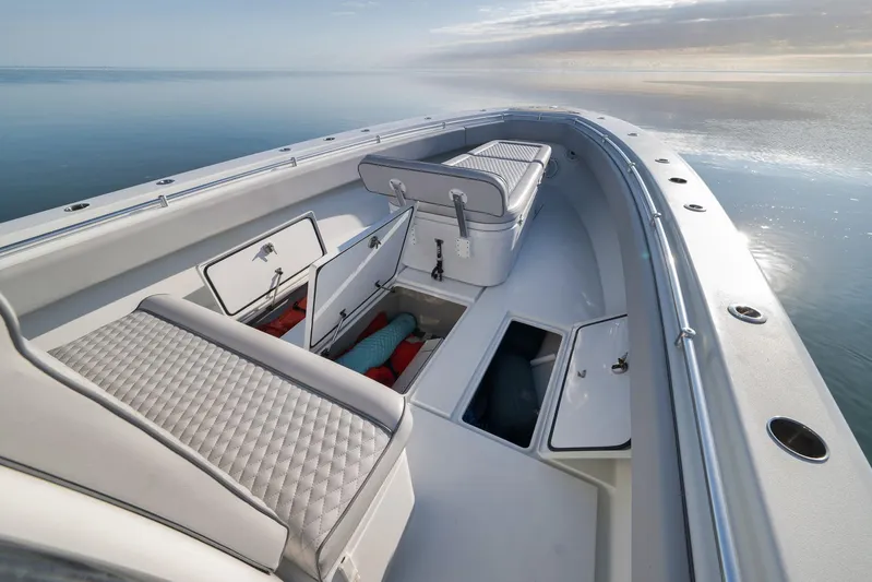  Yacht Photos Pics 2021 Contender 39 ST boat interior with open storage compartments on calm water.