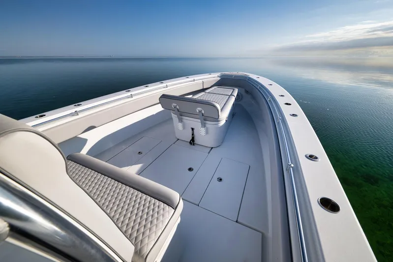 Yacht Photos Pics 2021 Contender 39 ST boat on calm water, featuring sleek design and spacious seating.