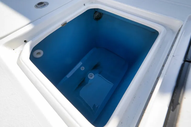  Yacht Photos Pics Livewell compartment on a 2021 Contender 39 ST boat, featuring a blue interior.