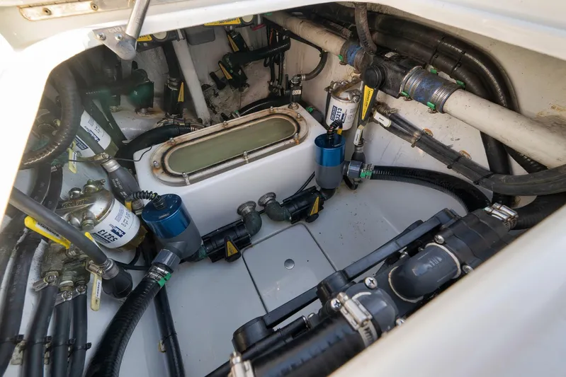  Yacht Photos Pics Engine compartment of 2021 Contender 39 ST boat, showcasing complex wiring and components.
