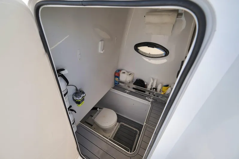 Yacht Photos Pics 2021 Contender 39 ST boat interior cabin with toilet and storage.