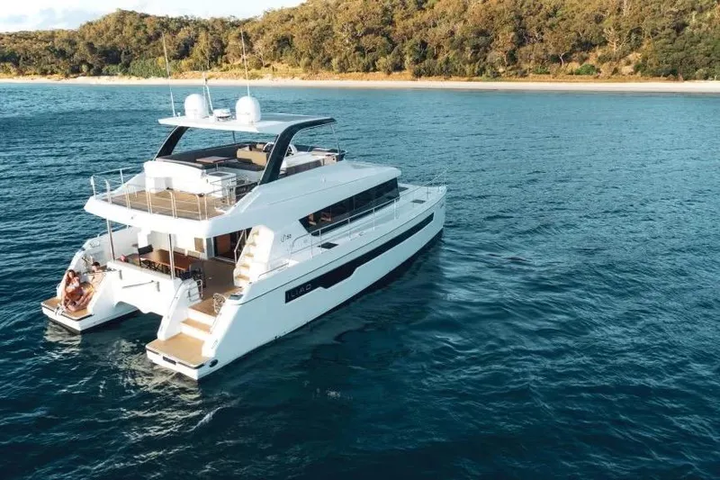  Yacht Photos Pics Luxurious 2022 ILIAD 50 yacht cruising near a scenic coastline.