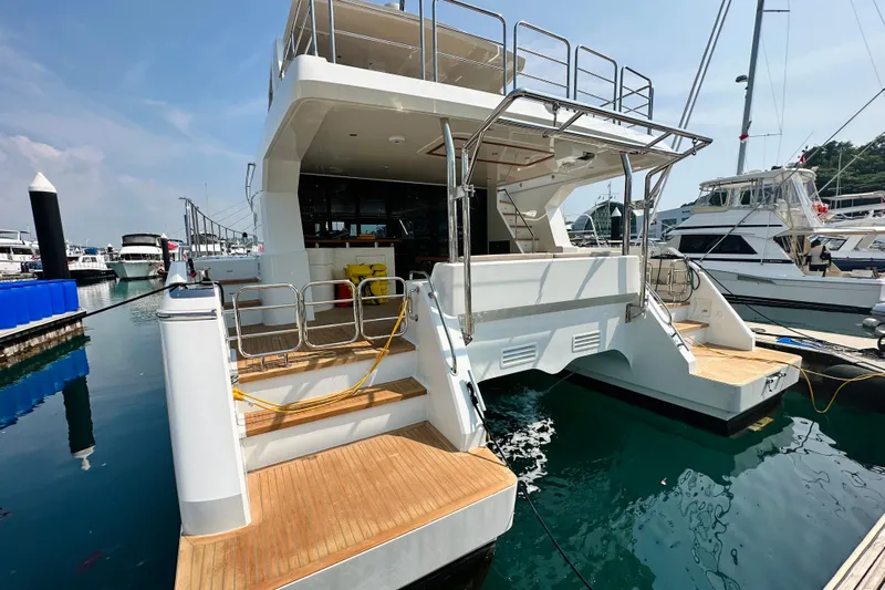  Yacht Photos Pics Luxury ILIAD 50 yacht docked at marina, showcasing sleek design and spacious deck.