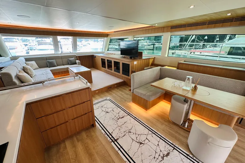  Yacht Photos Pics Luxurious ILIAD 50 yacht interior with modern seating, dining area, and large windows, 2022 model.