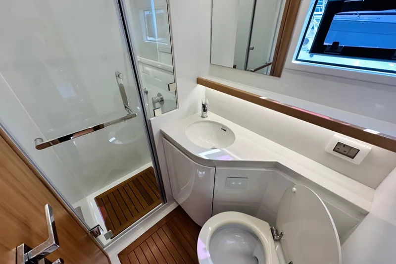  Yacht Photos Pics Modern yacht bathroom with shower, sink, and toilet in ILIAD 50, 2022 model.