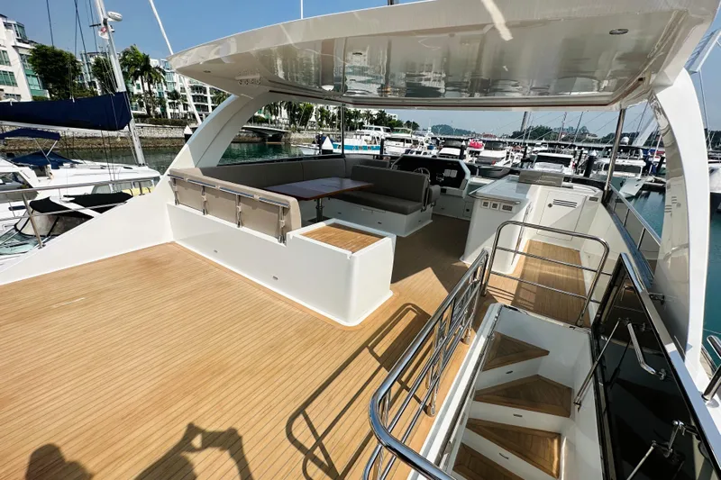  Yacht Photos Pics Luxurious 2022 ILIAD 50 yacht deck with seating area, docked at marina.