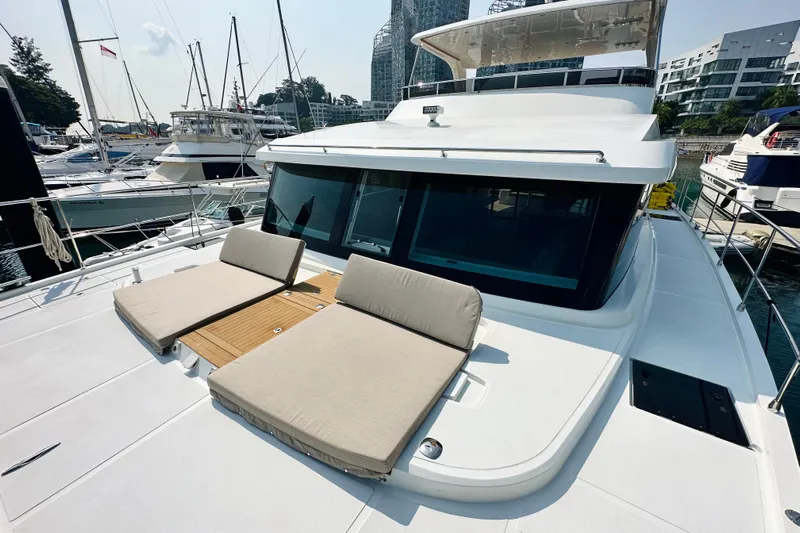  Yacht Photos Pics Luxury ILIAD 50 yacht with sun loungers, docked at a marina, 2022 model.