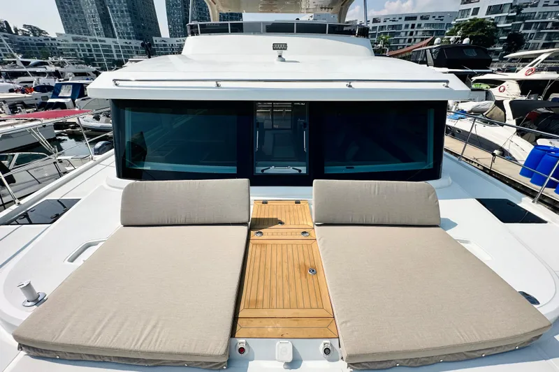  Yacht Photos Pics Luxurious 2022 ILIAD 50 yacht with sun loungers and modern design in marina setting.