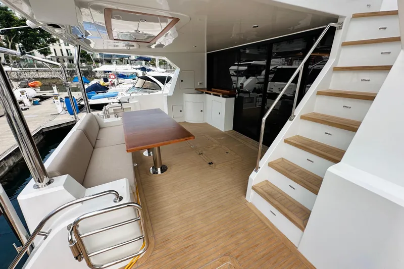  Yacht Photos Pics Luxurious ILIAD 50 yacht deck with seating, table, and stairs, 2022 model.