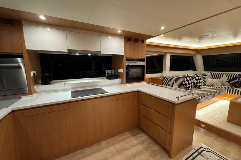  Yacht Photos Pics Luxurious interior of 2022 ILIAD 50 yacht with modern kitchen and cozy seating area.
