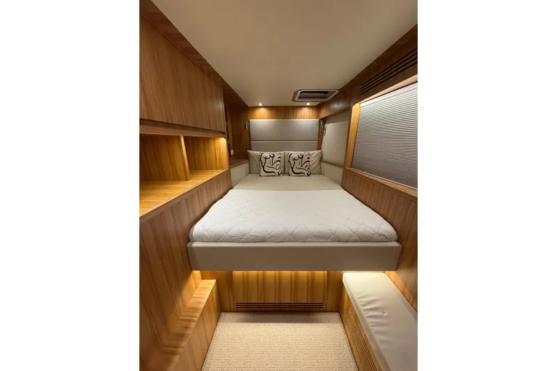  Yacht Photos Pics Luxurious ILIAD 50 yacht bedroom interior, featuring a cozy bed and elegant wooden finishes, 2022 model.
