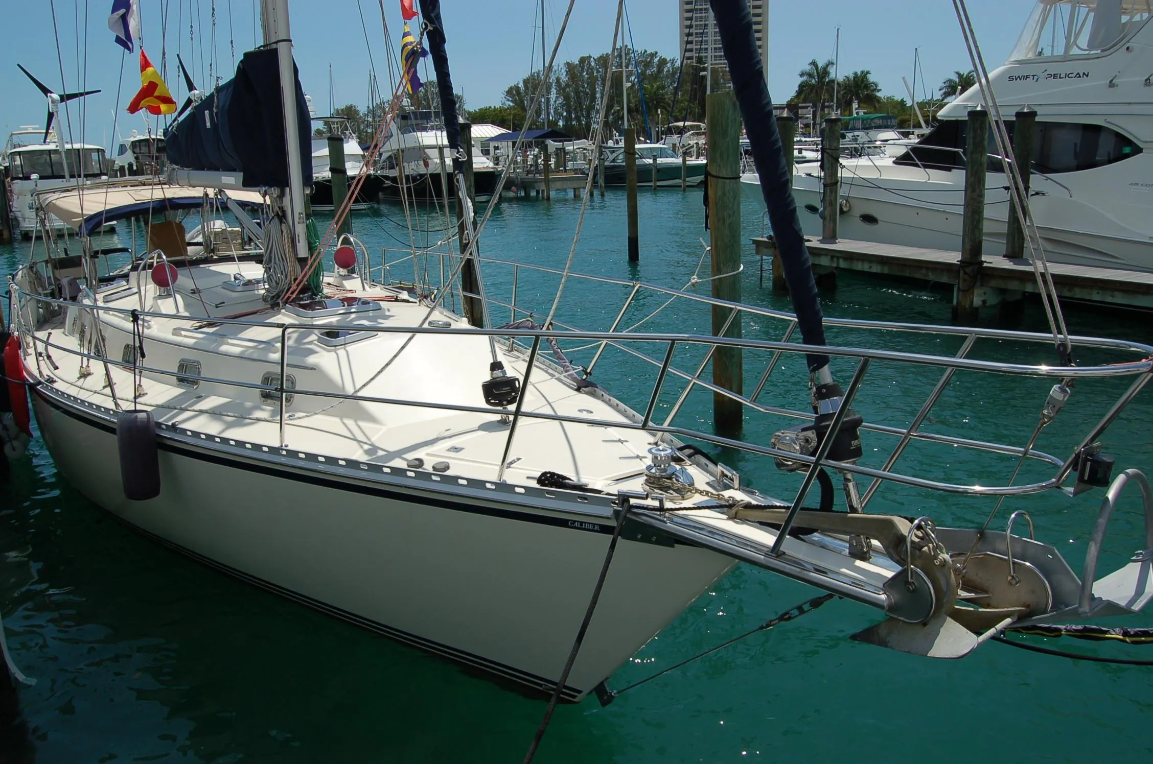 2005 Caliber 40 LRC SE sailboat docked in a marina with clear blue water.