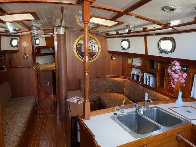 Entangled Yacht Photos Pics Interior of a 1988 Shannon 43 sailboat with wood finish and cozy seating area.