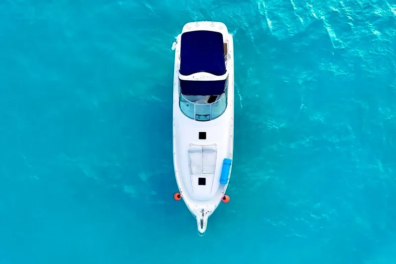Nauti Nauti Yacht Photos Pics Overhead view of 2000 Sea Ray 450 Express Bridge on turquoise water.