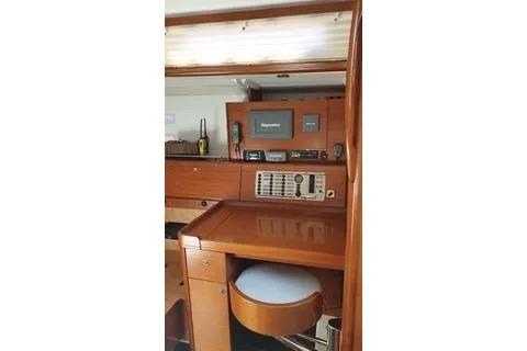  Yacht Photos Pics 2010 Dufour 45E Performance yacht interior with navigation equipment and wooden cabinetry.
