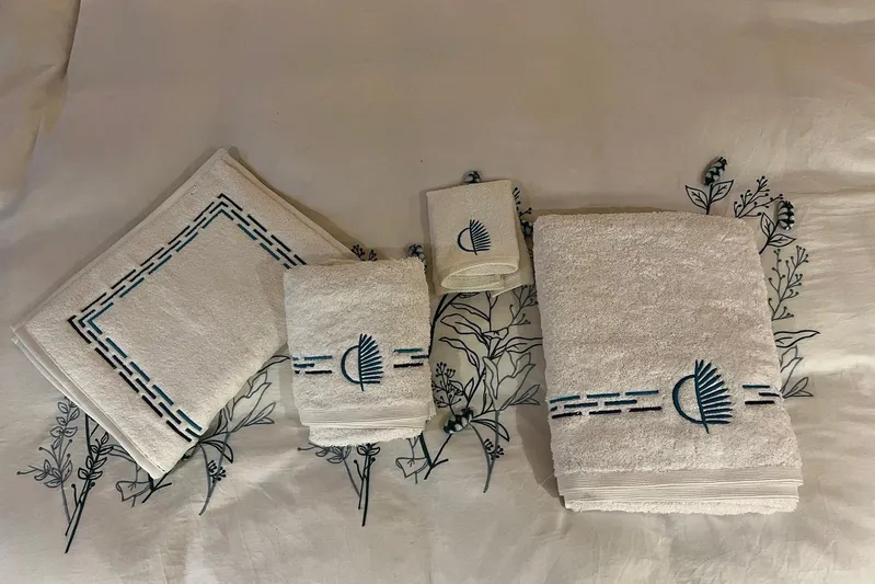 Chicago Yacht Photos Pics Luxury embroidered towels on floral-patterned fabric, featuring Lagoon 52 F 2020 design.