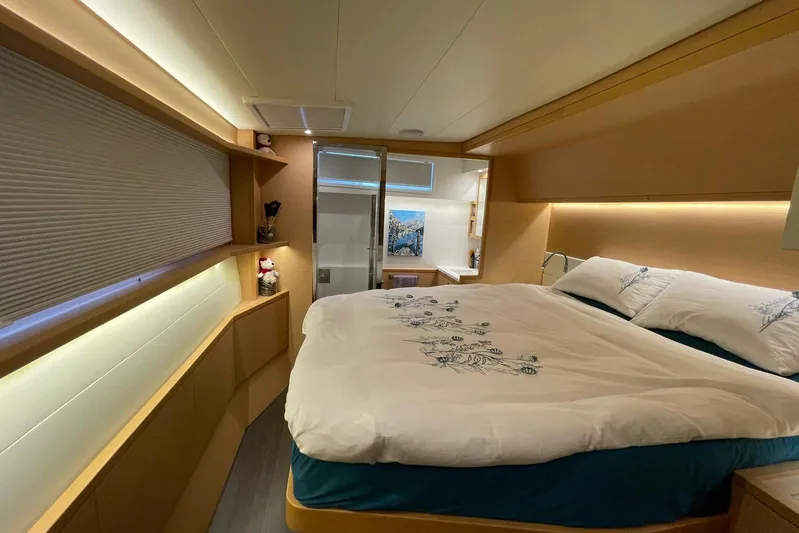 Chicago Yacht Photos Pics Luxurious bedroom interior of 2020 Lagoon 52 F yacht with elegant bedding and ambient lighting.