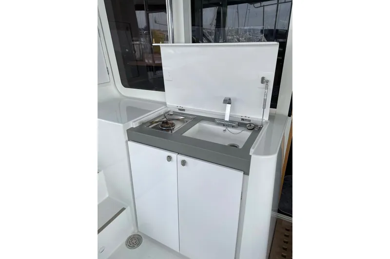 Chicago Yacht Photos Pics Compact kitchenette on 2020 Lagoon 52 F yacht with sink and stove.