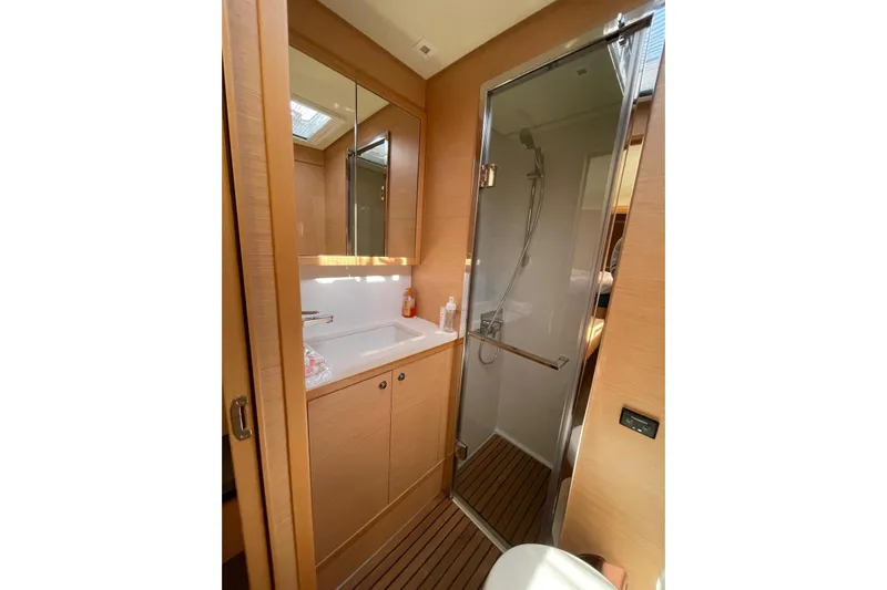 Chicago Yacht Photos Pics Modern bathroom in 2020 Lagoon 52 F yacht with shower and wooden accents.