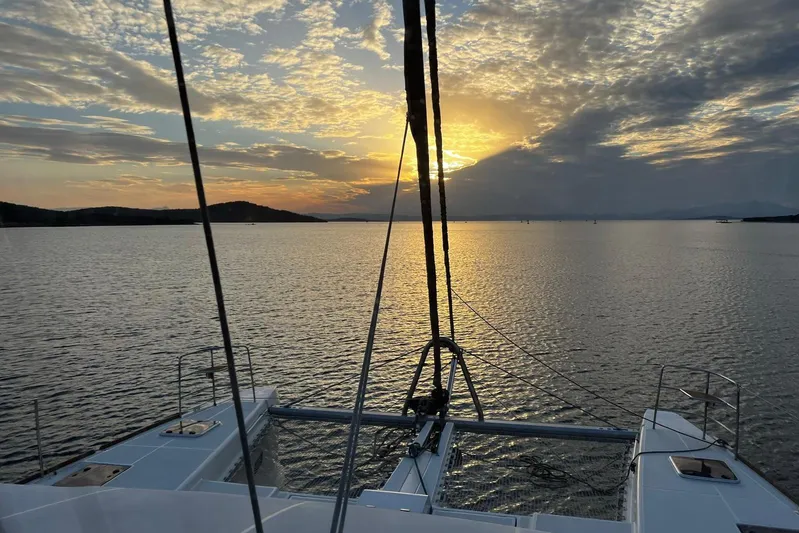 Chicago Yacht Photos Pics Lagoon 52 F catamaran sailing at sunset, 2020 model, serene ocean view.