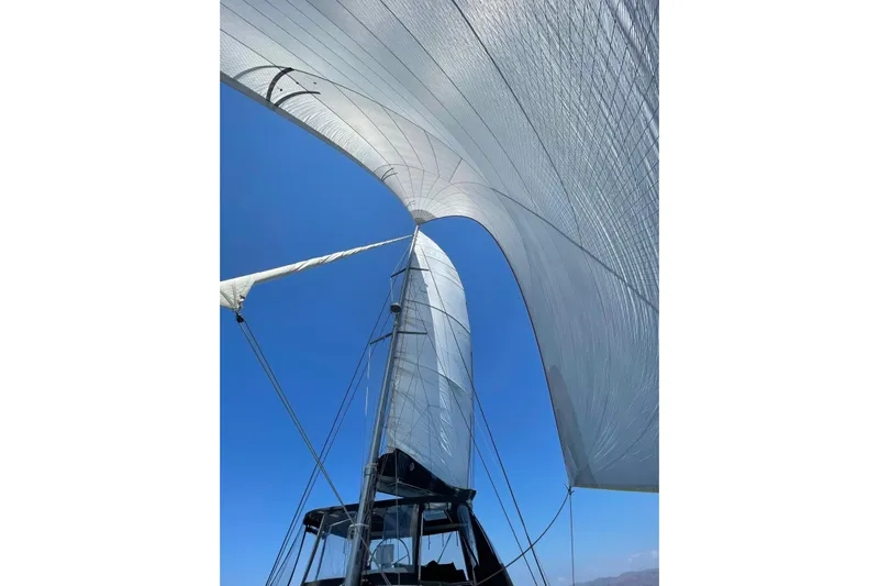 Chicago Yacht Photos Pics Sails of a 2020 Lagoon 52 F catamaran against a clear blue sky.