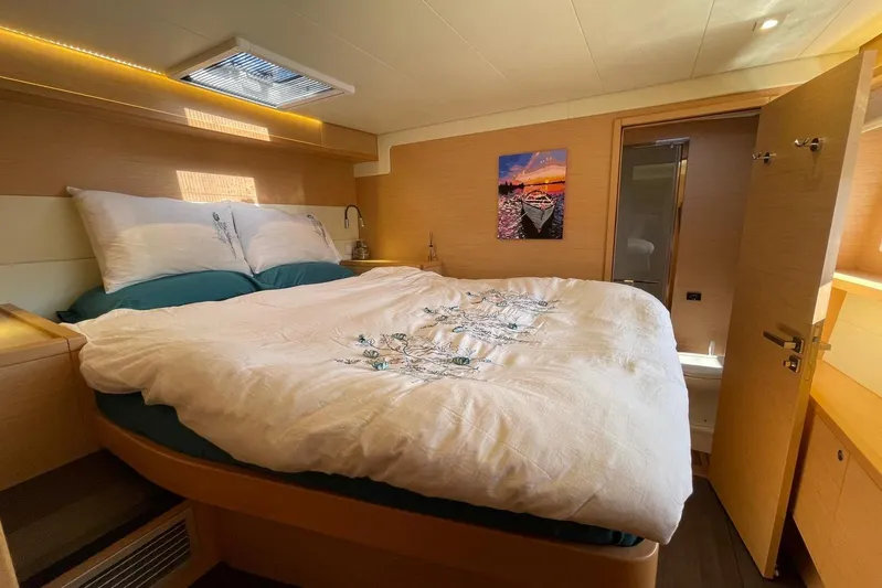 Chicago Yacht Photos Pics Luxurious bedroom interior of 2020 Lagoon 52 F yacht with cozy bedding and modern decor.