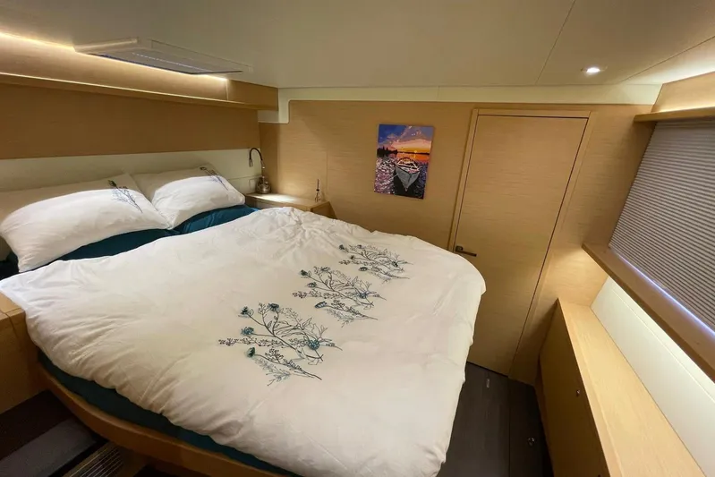 Chicago Yacht Photos Pics Luxurious bedroom interior of 2020 Lagoon 52 F yacht with elegant bedding and modern decor.