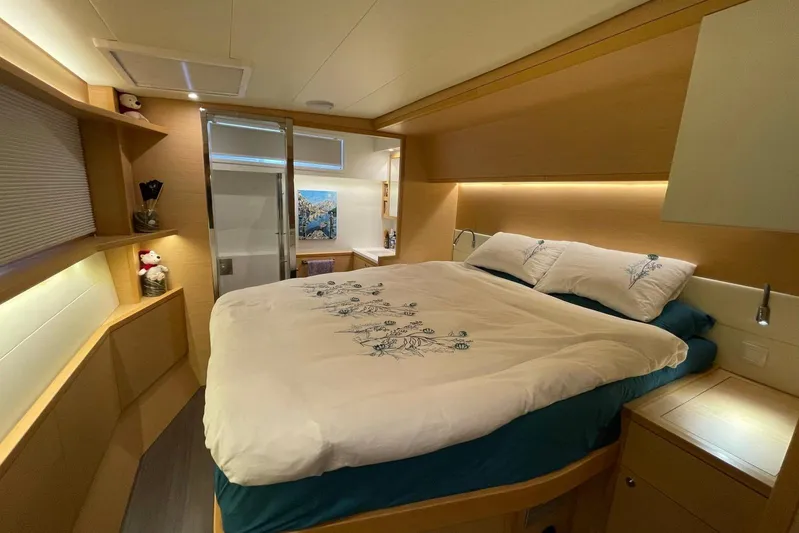 Chicago Yacht Photos Pics Luxurious bedroom interior of 2020 Lagoon 52 F yacht with modern design and cozy lighting.