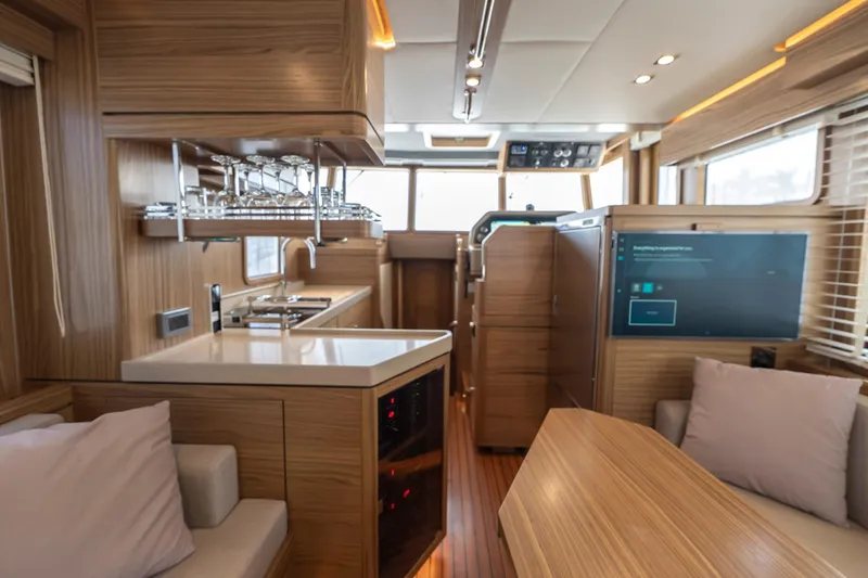  Yacht Photos Pics Luxurious interior of 2024 Nordhavn 41 yacht with modern kitchen and seating area.
