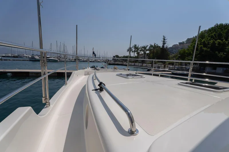  Yacht Photos Pics 2024 Nordhavn 41 yacht deck with marina view, palm trees, and clear blue sky.