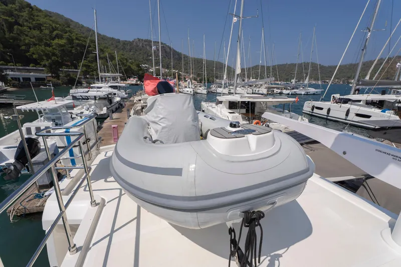  Yacht Photos Pics 2024 Nordhavn 41 yacht docked in marina with inflatable boat on deck.