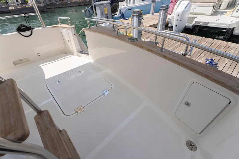  Yacht Photos Pics Spacious deck of 2024 Nordhavn 41 yacht at marina, featuring storage compartments.