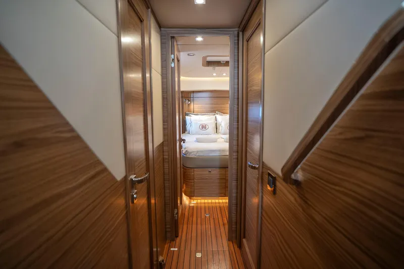  Yacht Photos Pics Luxurious interior of 2024 Nordhavn 41 yacht, featuring elegant wood paneling and cozy bedroom.