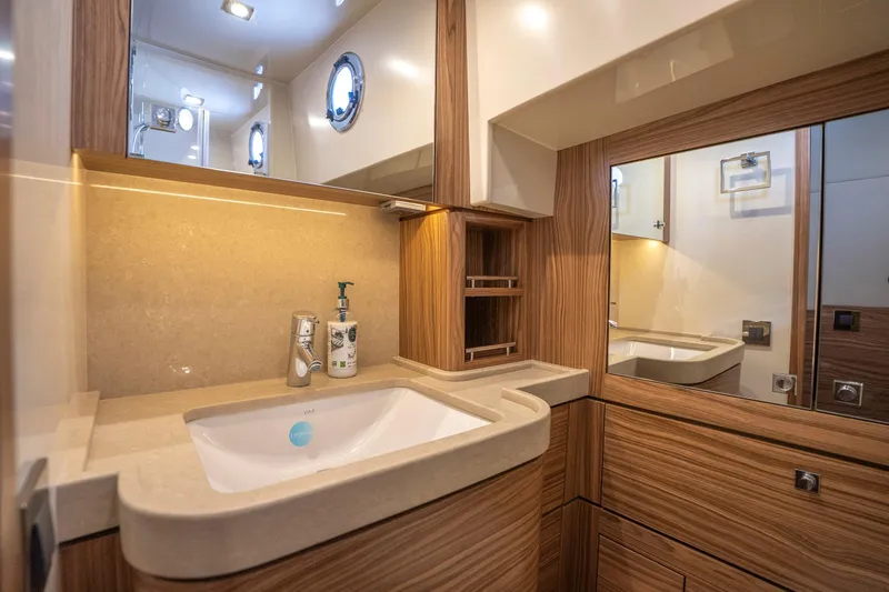  Yacht Photos Pics Luxurious bathroom interior of 2024 Nordhavn 41 yacht with modern sink and wood accents.