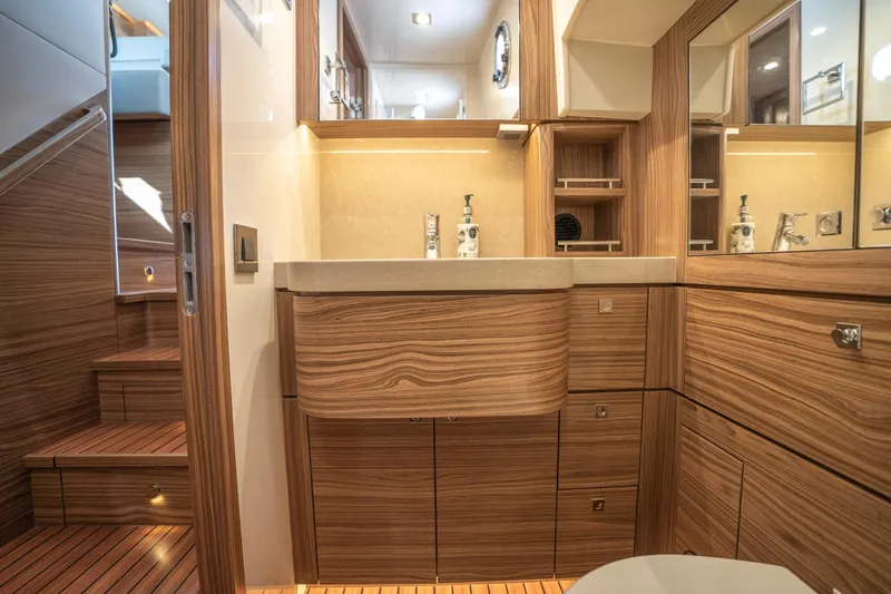  Yacht Photos Pics Luxurious bathroom interior of 2024 Nordhavn 41 yacht with wood finish and modern fixtures.