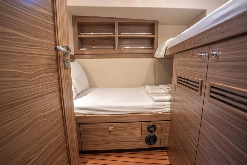  Yacht Photos Pics 2024 Nordhavn 41 cabin interior with wooden finish and cozy bed.
