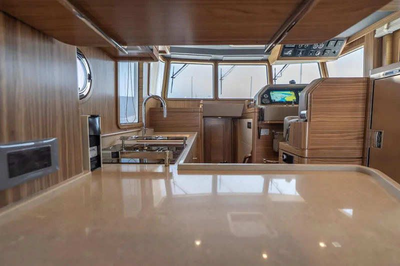  Yacht Photos Pics Luxurious interior of 2024 Nordhavn 41 yacht with modern kitchen and navigation area.