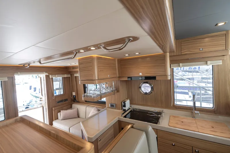  Yacht Photos Pics Luxurious interior of 2024 Nordhavn 41 yacht with modern kitchen and seating area.