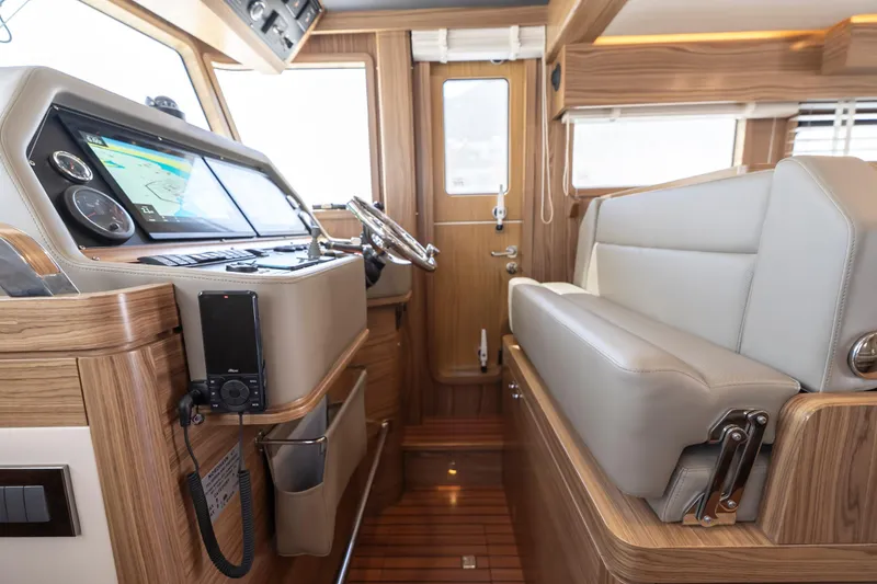  Yacht Photos Pics 2024 Nordhavn 41 yacht interior with modern navigation system and comfortable seating.