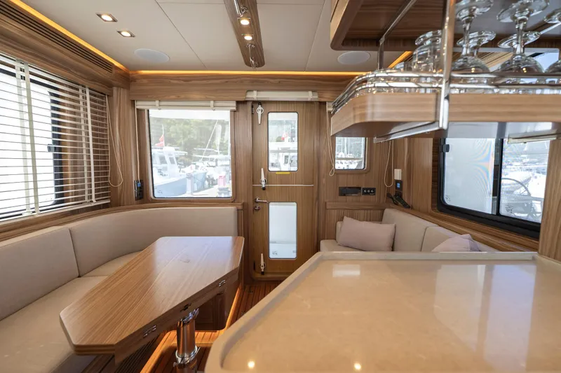  Yacht Photos Pics Luxurious interior of 2024 Nordhavn 41 yacht with elegant wood finish and modern amenities.
