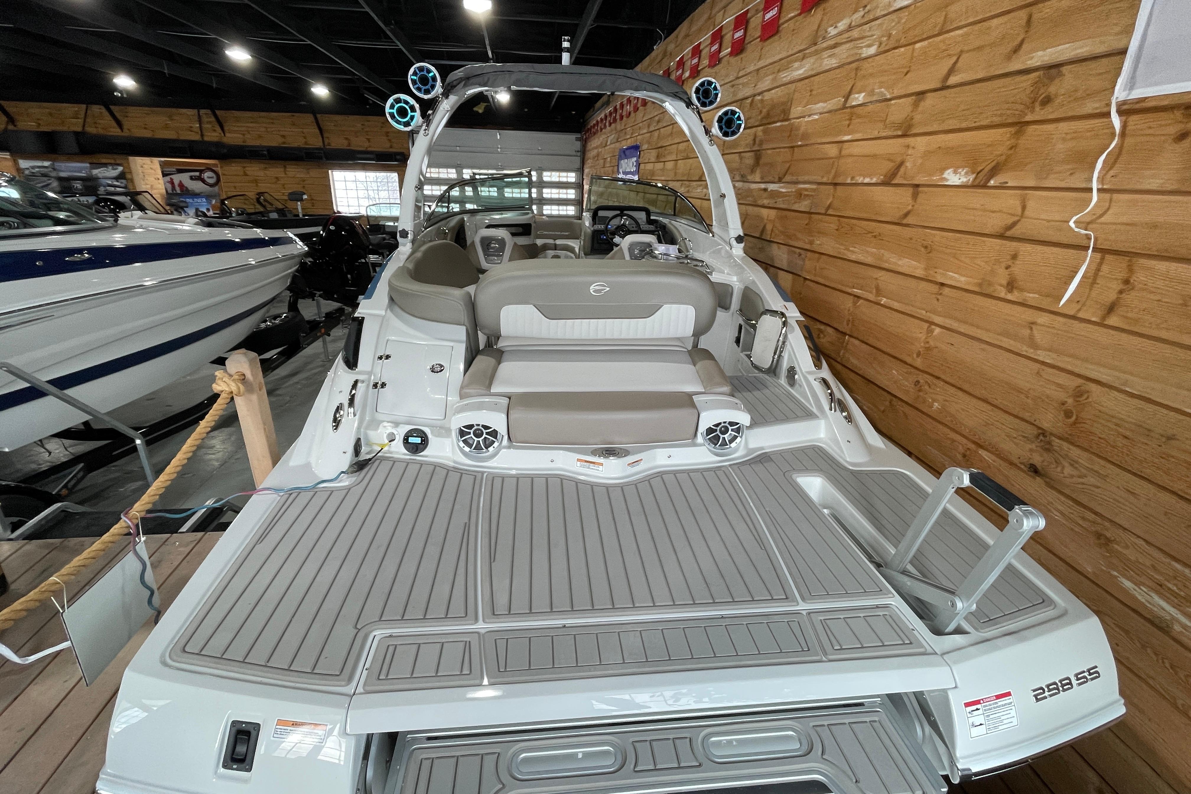 2026 Crownline 298 SS boat interior with seating and speakers in a showroom.