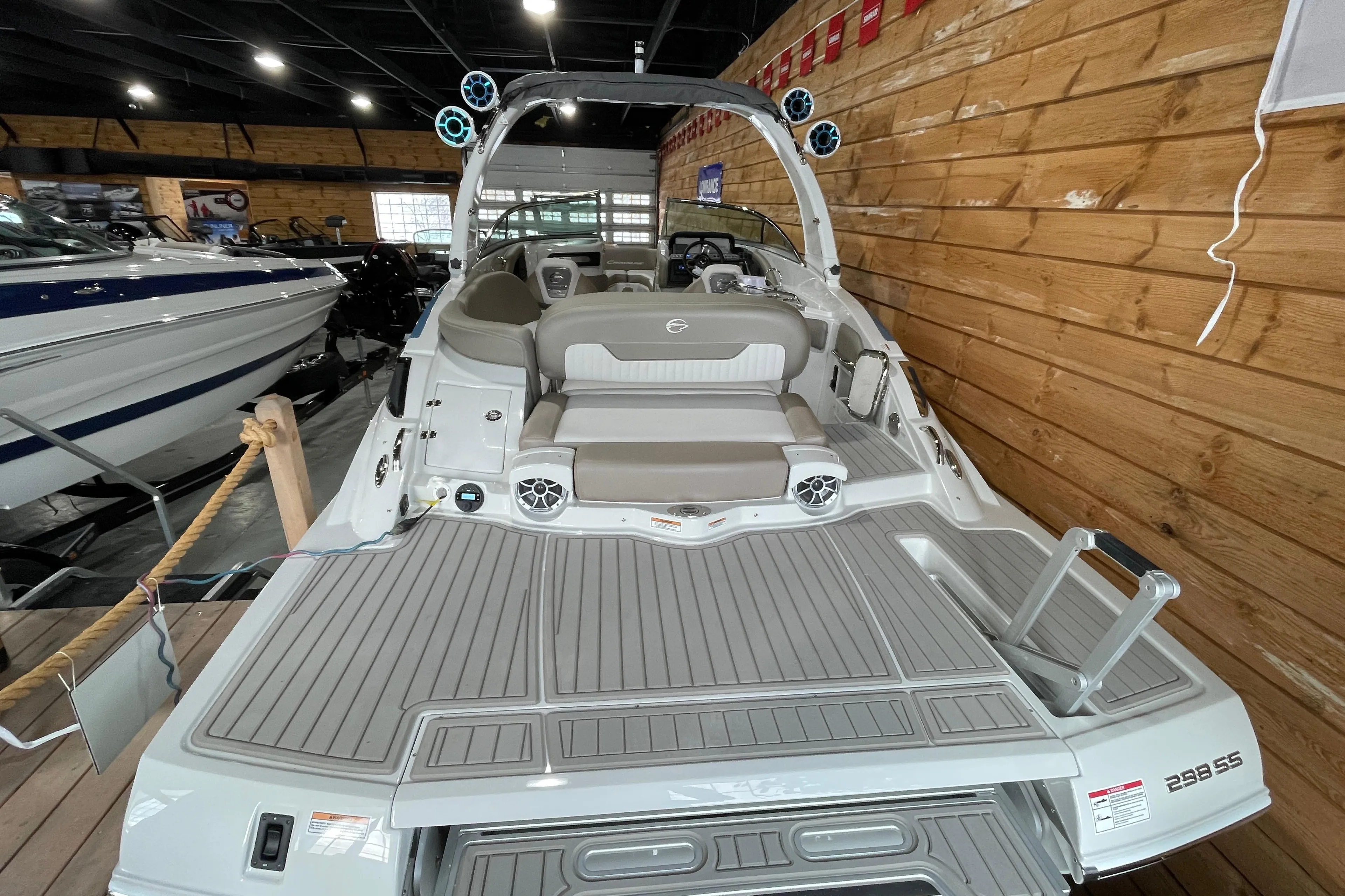 2026 Crownline 298 SS boat interior with seating and speakers in a showroom.