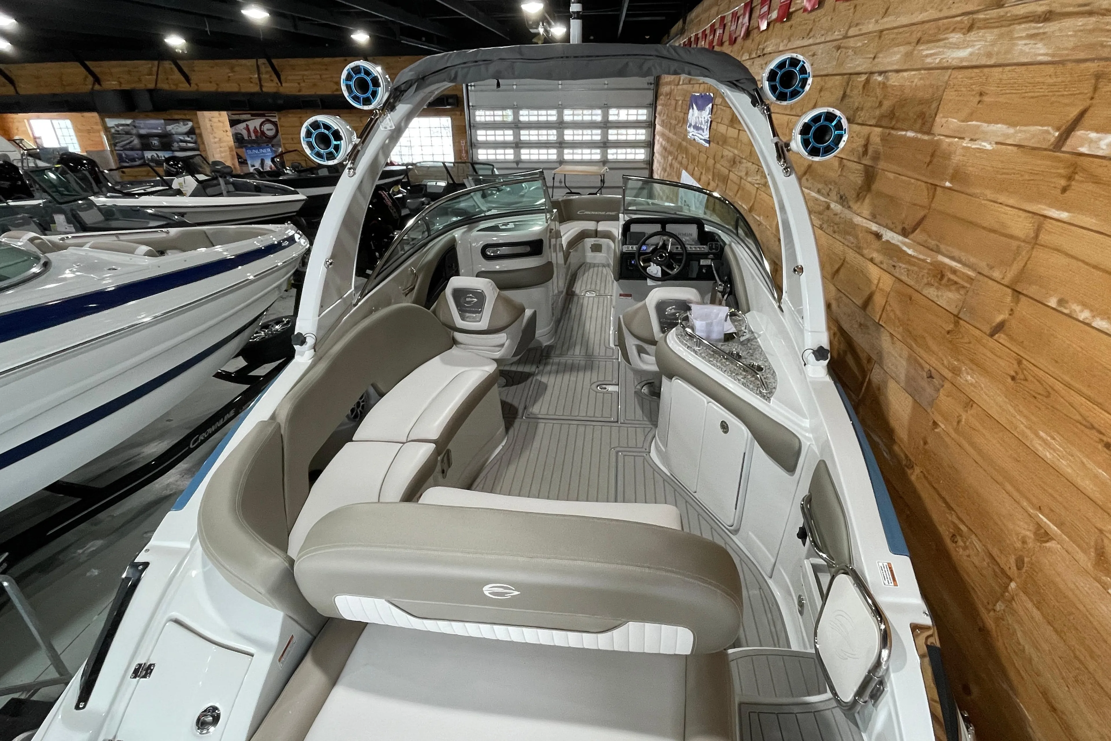 2026 Crownline 298 SS boat interior with modern seating and sleek design in showroom.