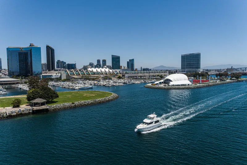 All Falked Up Yacht Photos Pics 1999 Carver 530 Voyager Pilothouse cruising in a vibrant city harbor with skyline views.