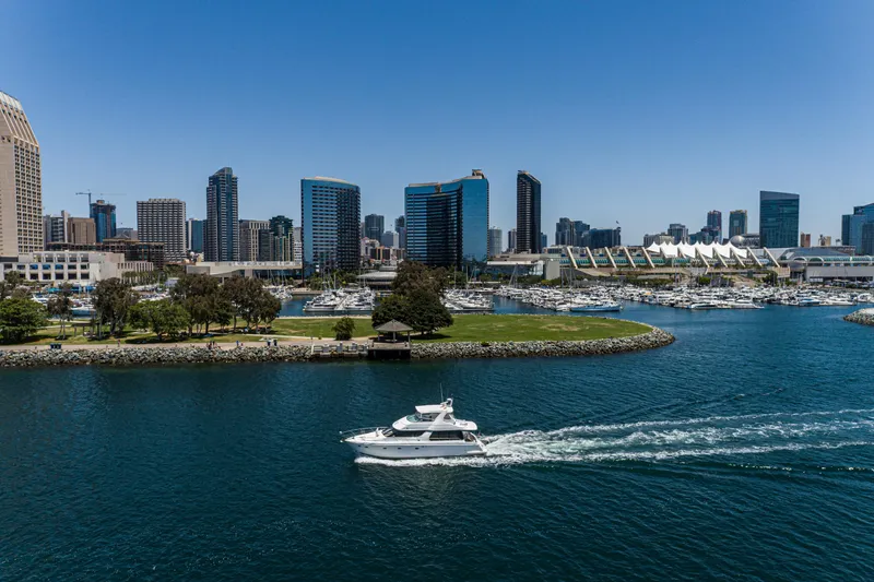 All Falked Up Yacht Photos Pics 1999 Carver 530 Voyager Pilothouse cruising near city skyline and marina.