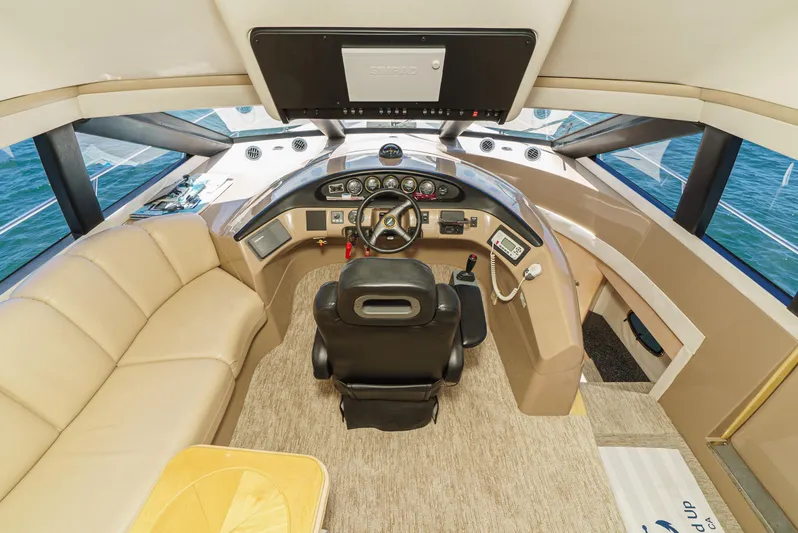 All Falked Up Yacht Photos Pics 1999 Carver 530 Voyager Pilothouse helm with luxurious seating and modern controls.