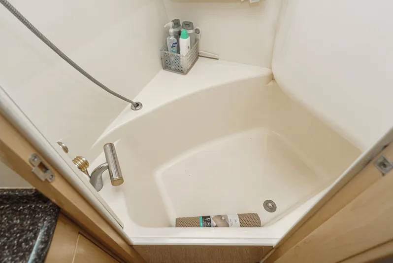 All Falked Up Yacht Photos Pics Shower area in 1999 Carver 530 Voyager Pilothouse with toiletries and handheld showerhead.
