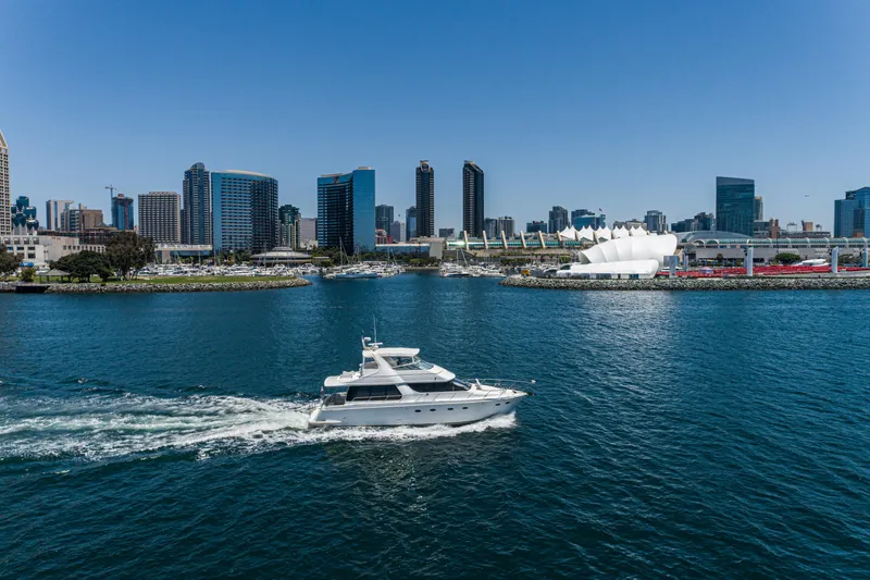 All Falked Up Yacht Photos Pics 1999 Carver 530 Voyager Pilothouse yacht cruising in urban waterfront with city skyline.